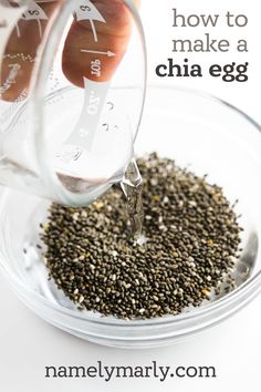 someone pouring chia seeds into a glass bowl