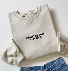 Embroidered I Closed My Book To Be Here Sweatshirt, Embroidered Book Sweatshirt, Bookish Gifts, Gift For Reader, Book Sweater, Book Gifts Material: 80% ring spun, combed cotton (softest, most durable and most environmentally friendly cotton around 20% polyester. This sweatshirt features super high quality embroidery, meaning your sweatshirt will last and last, wash after wash. This way you can wear it as many times as you wish and reduce wastage at the same time. Soft cotton faced fabric. Stylish fit and lining. Set-in sleeves. Taped neck. Ribbed collar cuffs and hem. Twin needle stitching. Worldwide Responsible Accredited Production (WRAP) certified production. Supersoft brushed inner fabric. Fit: Slightly oversized, stylish fit. The embroidery on this sweatshirt can be applied to other g Book Shirts Aesthetic, Book Club Merch, Cute Embroidered Sweatshirt, Bookish Sweaters, Book Hoodies, Bookish Clothes, Book Sweatshirts, Bookish Sweatshirts, Bookish Accessories