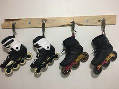 four roller skates are hanging on a wall