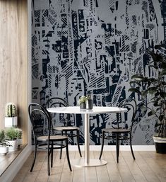 two chairs and a table in front of a wall