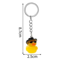 a rubber duck keychain with a hat and sunglasses on it's head