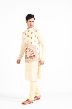 Rajasthani floral Hand embroidered nehru kurta set made in cream bamberg raw silk. Paired with cream slim fit Pant Pajama. Color of the actual garment may vary due to lighting conditions during the shoot.

Size Chart For Men





	
	
					Men's Size Chart
		

		
		
						
				Size Chart For Men
				Custom Size Measurement Guide
			
			
				
				
				Custom Size Measurement Guide
1. Take your measurements at ease…don’t hold your breath!
2. Be a little generous with the measurements. It’s always e Festive Nehru Jacket With Floral Embroidery In Cotton Silk, Cream Cotton Silk Kurta With Resham Embroidery, Semi-stitched Raw Silk Nehru Jacket With Chikankari Embroidery, Designer Cream Kurta With Floral Embroidery, Traditional Cotton Bandhgala With Floral Embroidery, Traditional Chanderi Bandhgala With Chikankari Embroidery, Raw Silk Bandhgala With Chikankari Embroidery For Festivals, Cream Embroidered Cotton Silk Set, Festive Cream Cotton Silk Traditional Wear