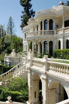 a large white house with many windows and balconies