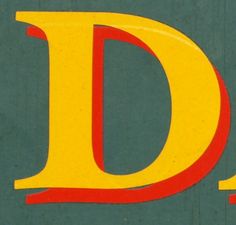 a close up of the letter d on a green background