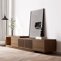 a wooden entertainment center with an art print on the wall