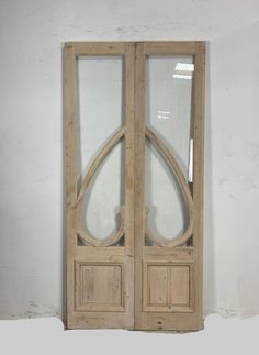 two wooden doors with glass panels on each side