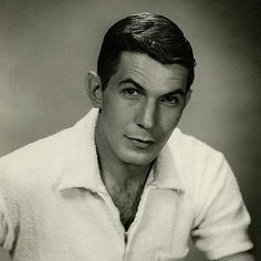 an old black and white photo of a man with short hair wearing a polo shirt