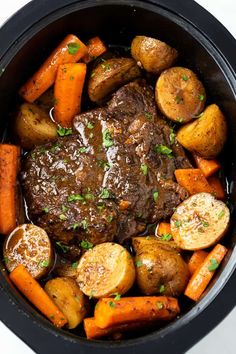 a pot roast with carrots, potatoes and parsley