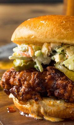 a chicken sandwich with lettuce and cole slaw