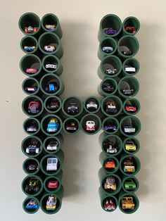 the letter h is made up of many different toy cars on it's sides