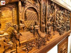 an intricately carved wooden panel with figures on it