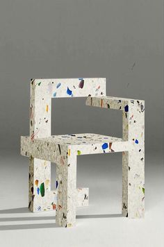 two chairs made out of paper with different shapes and colors on the back one chair is shaped like a rectangle