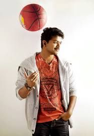 a man standing in front of a basketball on top of a white wall next to a red ball