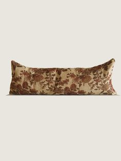 a rectangular pillow with floral print on the front and back, sitting on a white surface