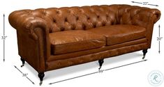 a brown leather couch sitting on top of a wooden table