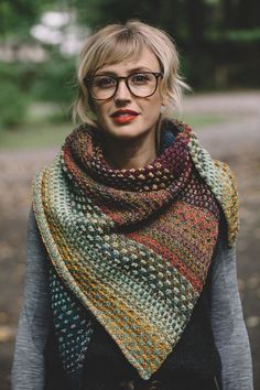 a woman wearing glasses and a multicolored shawl