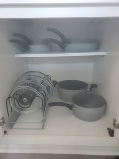 pots and pans are stored in the cupboard