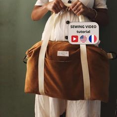 a woman holding a brown bag with the words sewing video on it's side