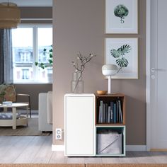 a living room filled with furniture and pictures on the wall