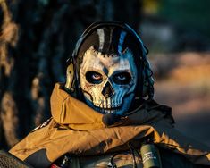 a man wearing a skull face paint on his helmet