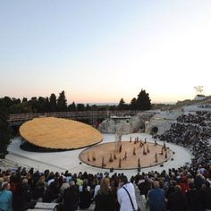 an aerial view of a stage with people standing on it and in front of the audience