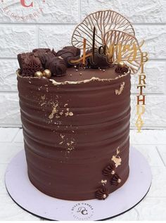 a chocolate cake with gold decorations on top and the number forty one written on it