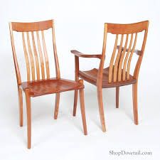 two wooden chairs sitting next to each other