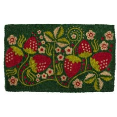 a green door mat with strawberries and flowers on the front, one side is red