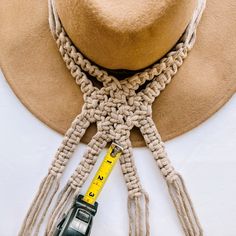 a hat, tie and measuring tape are laid out on top of a white table