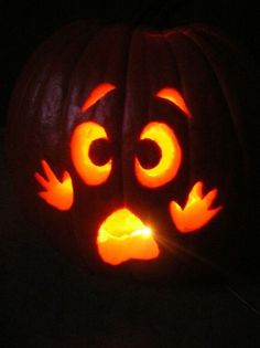 a carved pumpkin with an angry face on it's face and eyes glowing in the dark