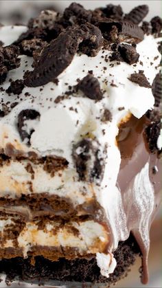 an ice cream cake with oreo cookies and white frosting on it's top