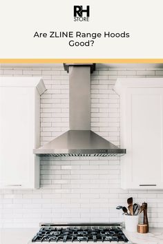 a stove top oven sitting inside of a kitchen next to white cabinets and counter tops