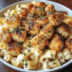 a white bowl filled with pasta and chicken