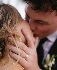 a bride and groom kissing each other