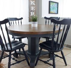 a kitchen table with four chairs around it