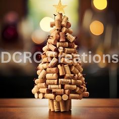 a small christmas tree made out of wine corks on a table with lights in the background