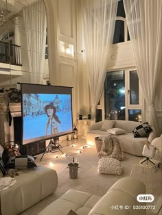 a living room filled with furniture and a flat screen tv mounted to the side of a wall