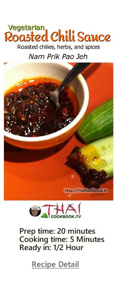 a bowl of chili sauce next to a cucumber on an orange tablecloth