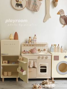 there is a playroom with toys on the floor and in front of an oven