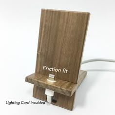 a wooden device holder with the words fraction fit on it's front and back sides