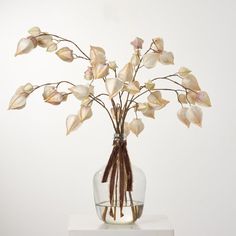 a vase filled with flowers on top of a white table