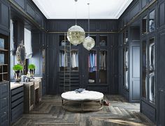 a large walk - in closet with dark wood floors and chandelier hanging from the ceiling