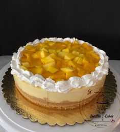 there is a cake that has been decorated with pineapples and whipped cream on top