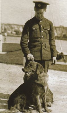 a man in uniform standing next to a dog