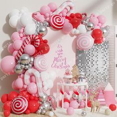 a pink and white christmas themed party with balloons, candy canes and other decorations