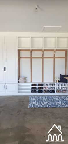 an empty room with white closets and blue rug on the floor in front of it