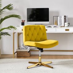 a bright yellow office chair sits in front of a desk with a computer on it