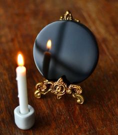 a candle and mirror on a wooden table