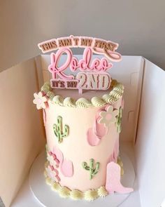 a pink and white birthday cake in a box