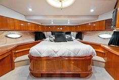 a bed sitting inside of a bedroom on top of a boat